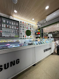 Side view of USED MOBILES shop showing organized phone accessory wall